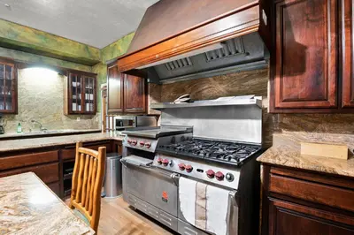 a kitchen with a stove and a counter top at Mountain High Luxury Castle &Spa in Wrightwood
