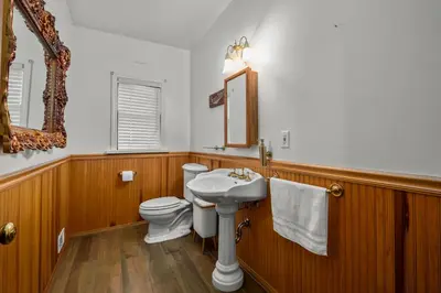 a bathroom with a white toilet and a sink at Mountain High Luxury Castle &Spa in Wrightwood
