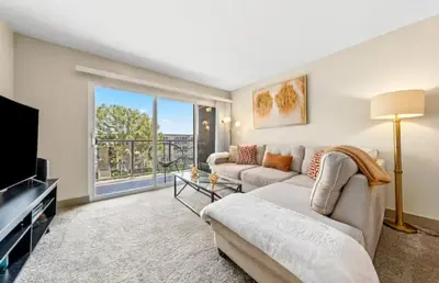 a living room with a couch and a tv at The Moonstone - Cozy Marina side Garden View Pool and Gym in Los Angeles