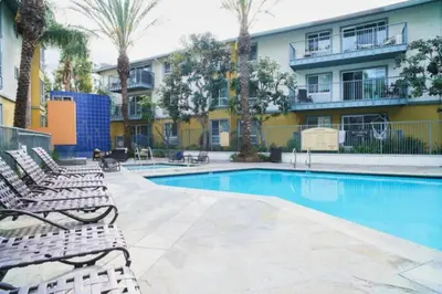 a swimming pool with lounge chairs and a building at The Moonstone - Cozy Marina side Garden View Pool and Gym in Los Angeles