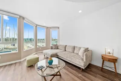 a living room with a couch and a glass table at Harbor Views Retreat By Venice Beach In Marina DR in Los Angeles