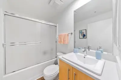 a white bathroom with a sink and a toilet at Harbor Views Retreat By Venice Beach In Marina DR in Los Angeles