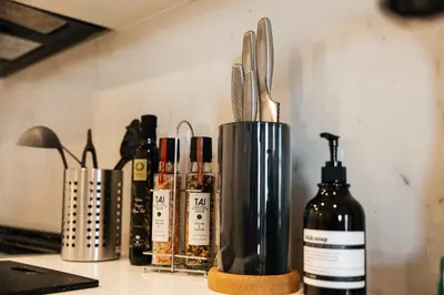 a group of utensils in a container on a counter at Elegant Apartment in the Heart of Hollywood in Los Angeles
