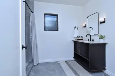 a bathroom with a sink and a mirror at Beautiful 3 Bed Home with a Large Back Yard Outdoor Space in Los Angeles