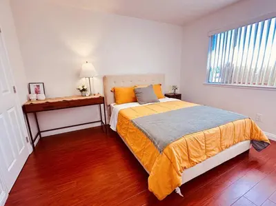 a bedroom with a large bed and a window at Charming 3BR Retreat near Disneyland Downtown LA! in Rowland Heights