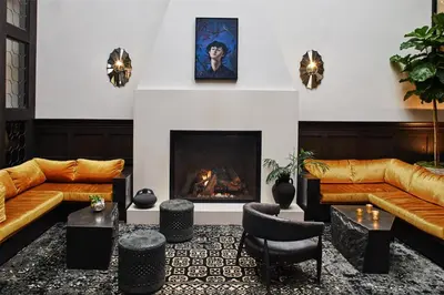 a living room with couches and a fireplace at Hotel Figueroa, Unbound Collection by Hyatt in Los Angeles