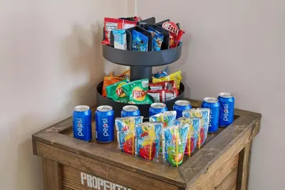 a shelf with a bunch of chips and drinks at The Disneyland Dream by OC Adventure Homes in Garden Grove