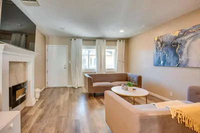a living room with a couch and a table at LA Condo about 1 Mi to The Kia Forum and SoFi Stadium in Inglewood