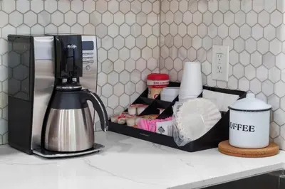 a kitchen counter with a coffee maker on a counter top at Gamers Getaway by OC Adventure Homes in Stanton