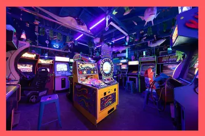 a room filled with lots of video game machines at Underwater Voyage by OC Adventure Homes in Garden Grove