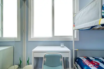 a bedroom with a desk and a bunk bed at Underwater Voyage by OC Adventure Homes in Garden Grove