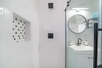 a bathroom with a shower and a sink and a mirror at Underwater Voyage by OC Adventure Homes in Garden Grove