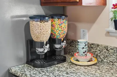 a kitchen counter with two vases filled with cereal at The Disneyland Dream by OC Adventure Homes in Garden Grove