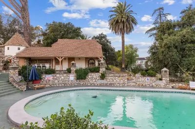 a swimming pool in front of a house at The Magic Castle (Unit5) - Six Flags in Newhall
