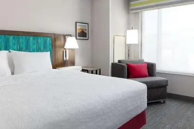 a hotel room with a bed and a chair at Hampton Inn & Suites Porter Ranch Los Angeles in Deer Lake Highlands