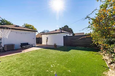 a backyard with a fence and a basketball hoop at Coastal Retreat With a minimum stay of 30 days in Lakewood