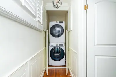 a washer and dryer in a hallway next to a door at Coastal Retreat With a minimum stay of 30 days in Lakewood