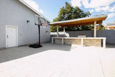 an outdoor basketball court with a basketball hoop at Beautiful Spacious Home in Los Angeles