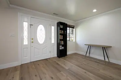 a room with a white door and a wooden table at Beautiful Spacious Home in Los Angeles