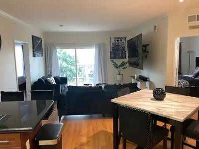 a living room with a table and a couch at Luxury 2 bedroom apartment in downtown LA! in Los Angeles