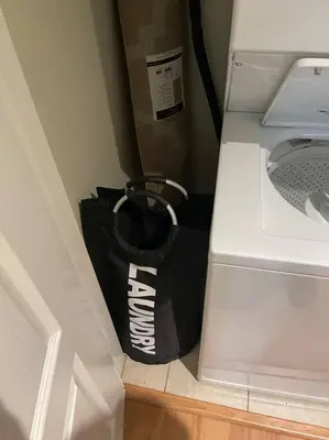 a black and white bag in a corner next to a washing machine at Luxury 2 bedroom apartment in downtown LA! in Los Angeles