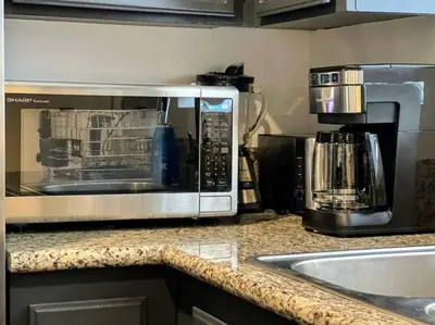 a kitchen counter with a microwave and a sink at 2BR Suite in the Heart of Hollywood -BR5 in Los Angeles