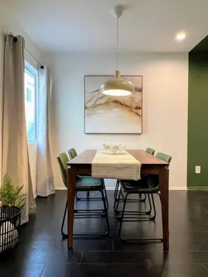a dining room with a table and green chairs at 2BR Suite in the Heart of Hollywood -BR5 in Los Angeles