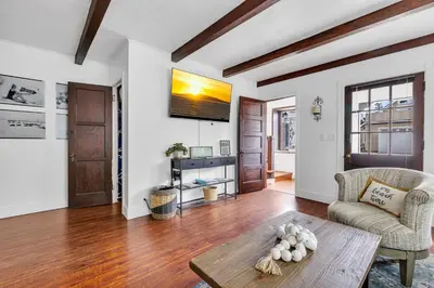 a living room with a table and a couch at Historic Spanish Home at Hollywood Beach in Oxnard