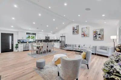 a living room with a table and chairs and a kitchen at LA Home near Universal Studios and Hollywood in Los Angeles