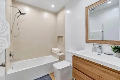 a white bathroom with a tub and a toilet and a sink at LA Home near Universal Studios and Hollywood in Los Angeles