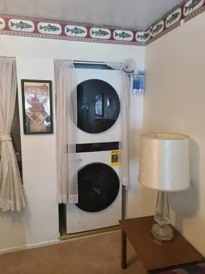 a washing machine in the corner of a room at A-Frame Cabin in The Sequoias in Wofford Heights