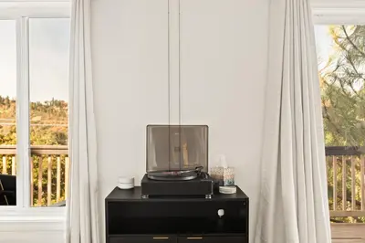a tv sitting on a dresser in a room with a window at EV level 2, Pets Welcome at Sunset Ridge in Lake Arrowhead
