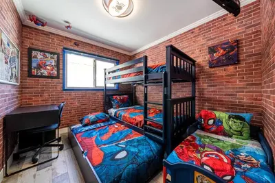 a bedroom with two bunk beds and a desk at Avengers Campus by OC Adventure Homes in Buena Park