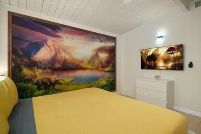 a bedroom with a painting on the wall at Dino Disneyland by OC Adventure Homes in Garden Grove