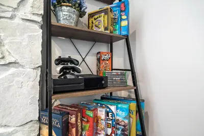 a shelf with snacks and a video camera on it at Pirate Cove by OC Adventure Homes in Garden Grove
