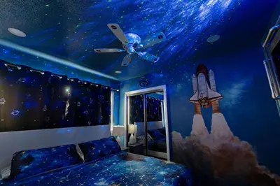 a bedroom with a starry ceiling and a rocket mural at Galaxy Quest by OC Adventure Homes in Garden Grove