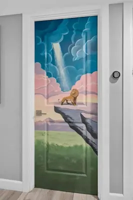 a door with a painting of a cat sitting on a cliff at Safari Adventure by OC Adventure Homes in Garden Grove