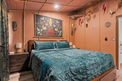 a bedroom with a bed and a painting on the wall at Safari Adventure by OC Adventure Homes in Garden Grove
