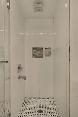 a shower with a glass door in a bathroom at Safari Adventure by OC Adventure Homes in Garden Grove