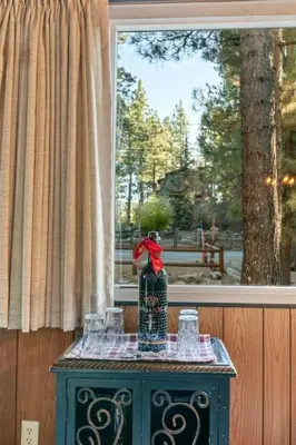 a vase sitting on top of a table in front of a window at Green Pines Lake Retreat Walk to Lake in Big Bear Lake