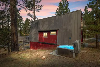 a small house with a pool in front of it at Lucky Bear Cabin in Big Bear Lake