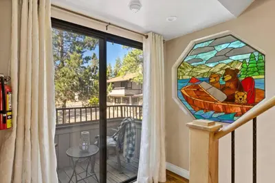 a stained glass window in a room with a balcony at Lakefront at the Village in Big Bear Lake