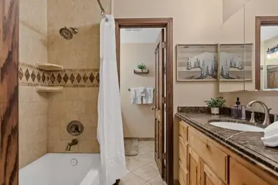 a bathroom with a tub and a sink at Lakefront at the Village in Big Bear Lake