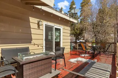 a screened porch with a table and chairs on a house at Slope Vista Escape in Fawnskin