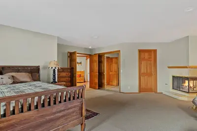 a bedroom with a bed and a fireplace at Roaring Lion Lakefront Lodge in Big Bear Lake