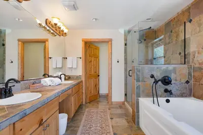 a bathroom with two sinks and a tub and a shower at Sky High Mountain Lodge Lake View in Big Bear Lake