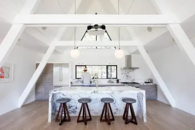 a kitchen with a large island in the middle of a room at Mountain Top Modern Lakefront in Sunset Magazine in Big Bear Lake
