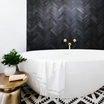 a white bath tub in a bathroom with a black wall at Mountain Top Modern Lakefront in Sunset Magazine in Big Bear Lake