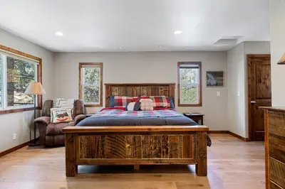 a bedroom with a large bed in a room at Snowcrest Lodge in Exclusive Fox Farm in Big Bear Lake