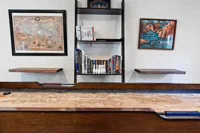 a counter with a book shelf with books at Snowcrest Lodge in Exclusive Fox Farm in Big Bear Lake